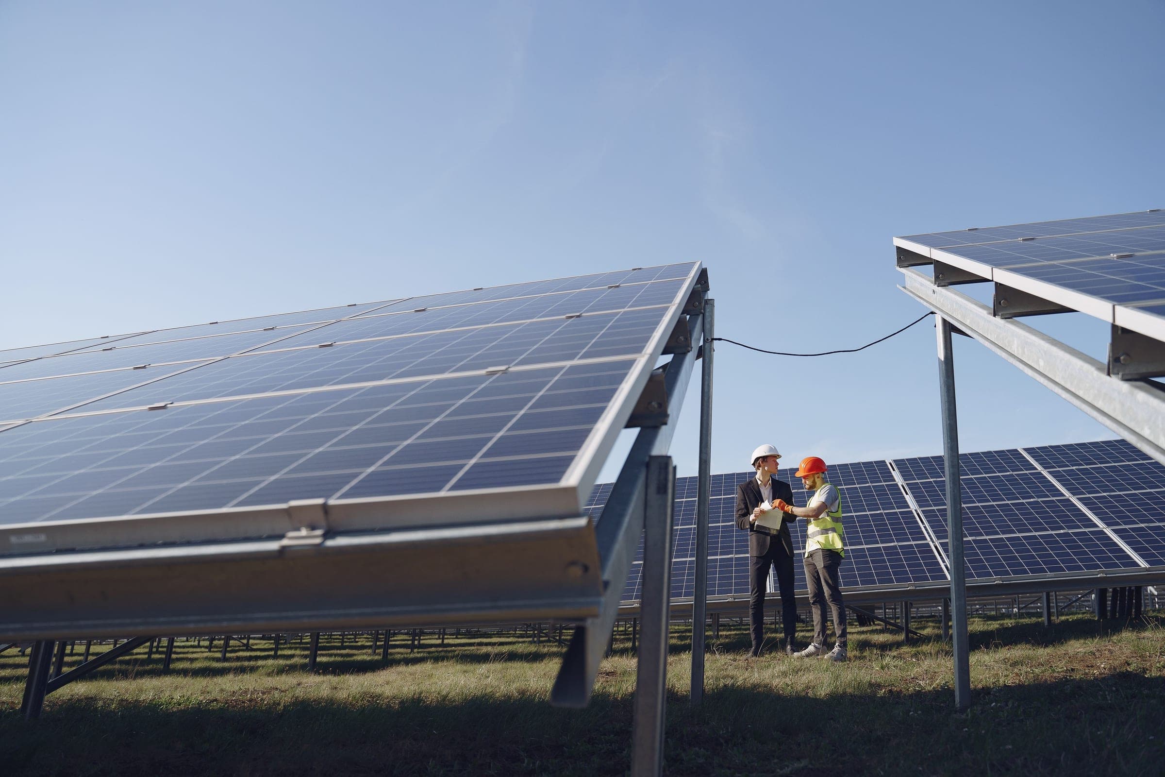 Engineers inspecting a utility-scale solar array